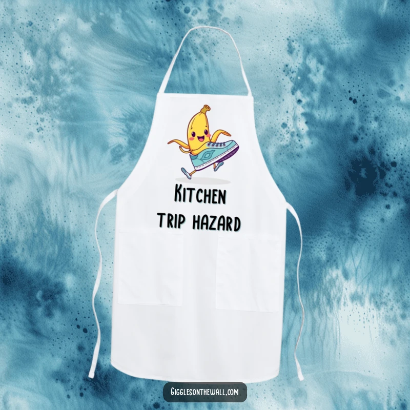 Funny apron with a smiling banana peel attempting to trip a running shoe, ideal for kitchen humor.