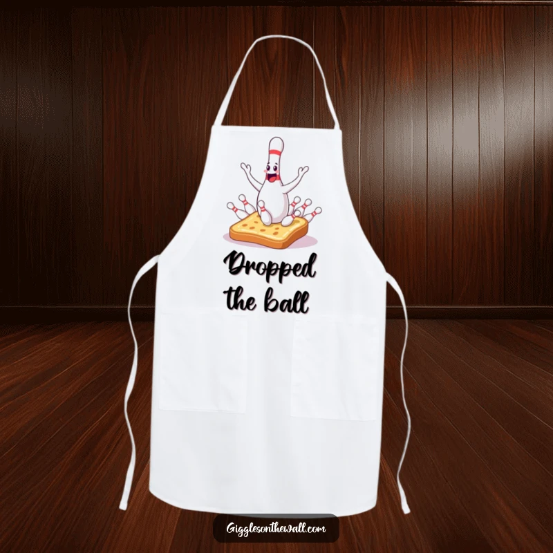 Funny bowling pin apron showing a sentient juggler dropping pins onto surprised toast, ideal for culinary fun and humorous chefs.