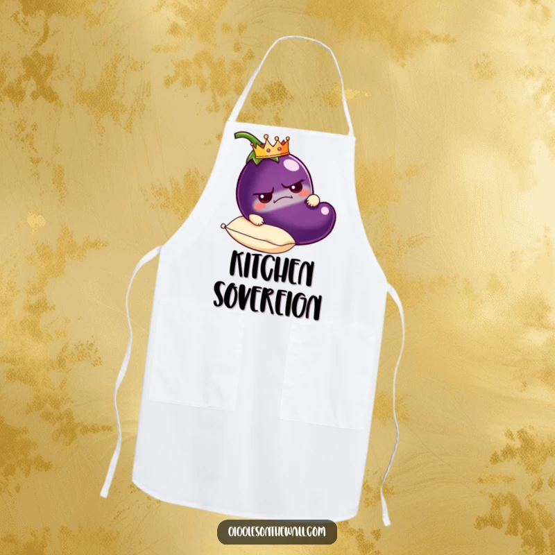 Funny grumpy eggplant apron wearing a crown, carried on a plush pillow, humorous and practical kitchen wear.