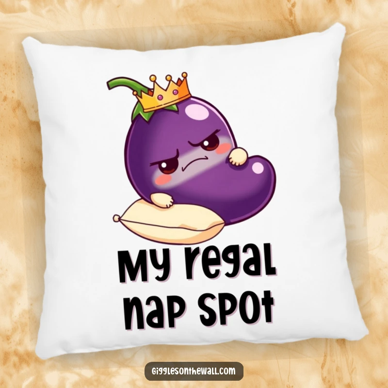 Funny grumpy eggplant pillow wearing a crown, resting on a plush pillow, soft and humorous decorative accent.