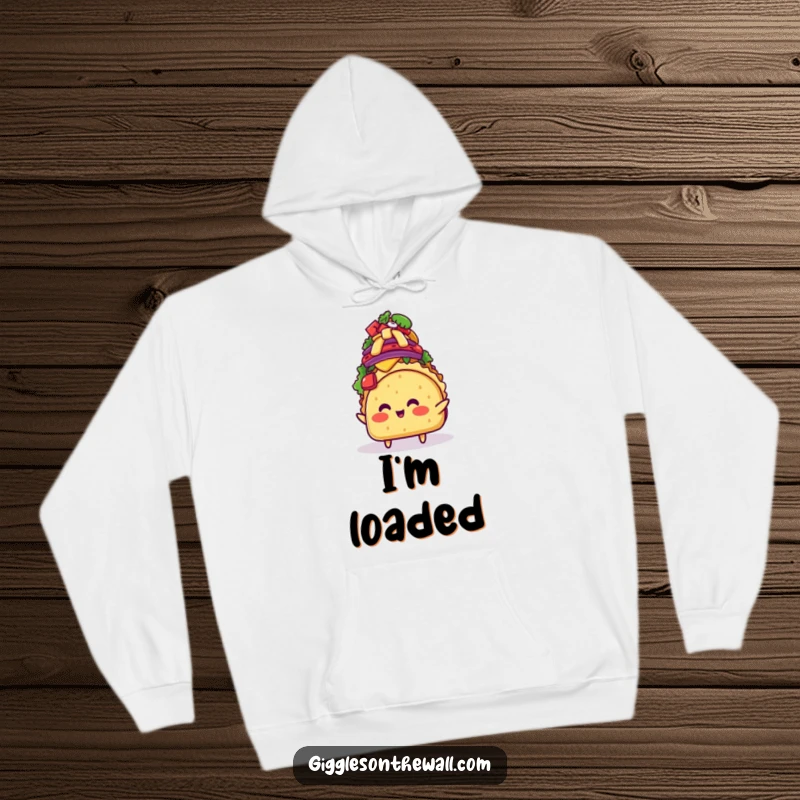 Funny blushing taco character teetering under a mountain of toppings, featured on a warm hoodie, offering comfort and comical culinary charm.