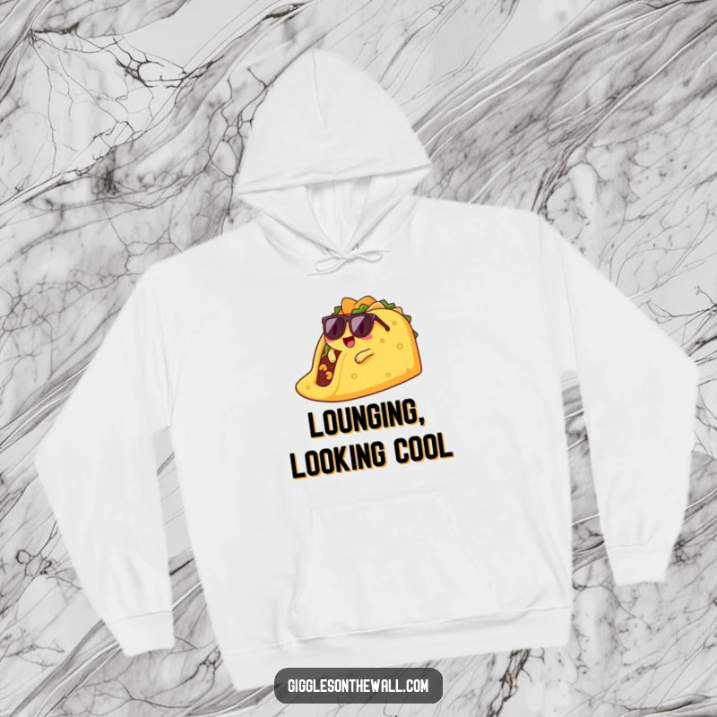 Funny lounging taco hoodie design shows a cool taco character in sunglasses, casually lounging on a giant chip.