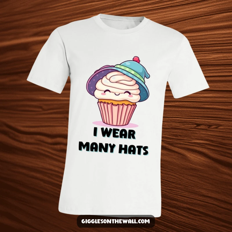 Funny t-shirt featuring a playful cupcake attempting to wear two hats at once, a humorous statement for ambitious souls, a great funny gift.